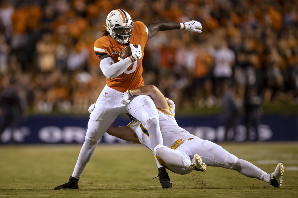 Sep 4, 2021; Charlottesville, Virginia, USA; Virginia Cavaliers tight end Jelani Woods (0) carries the ball against William & Mary Tribe linebacker Kevin Jarrell (19) during the first half at Scott Stadium. Mandatory Credit: Scott Taetsch-USA TODAY Sports